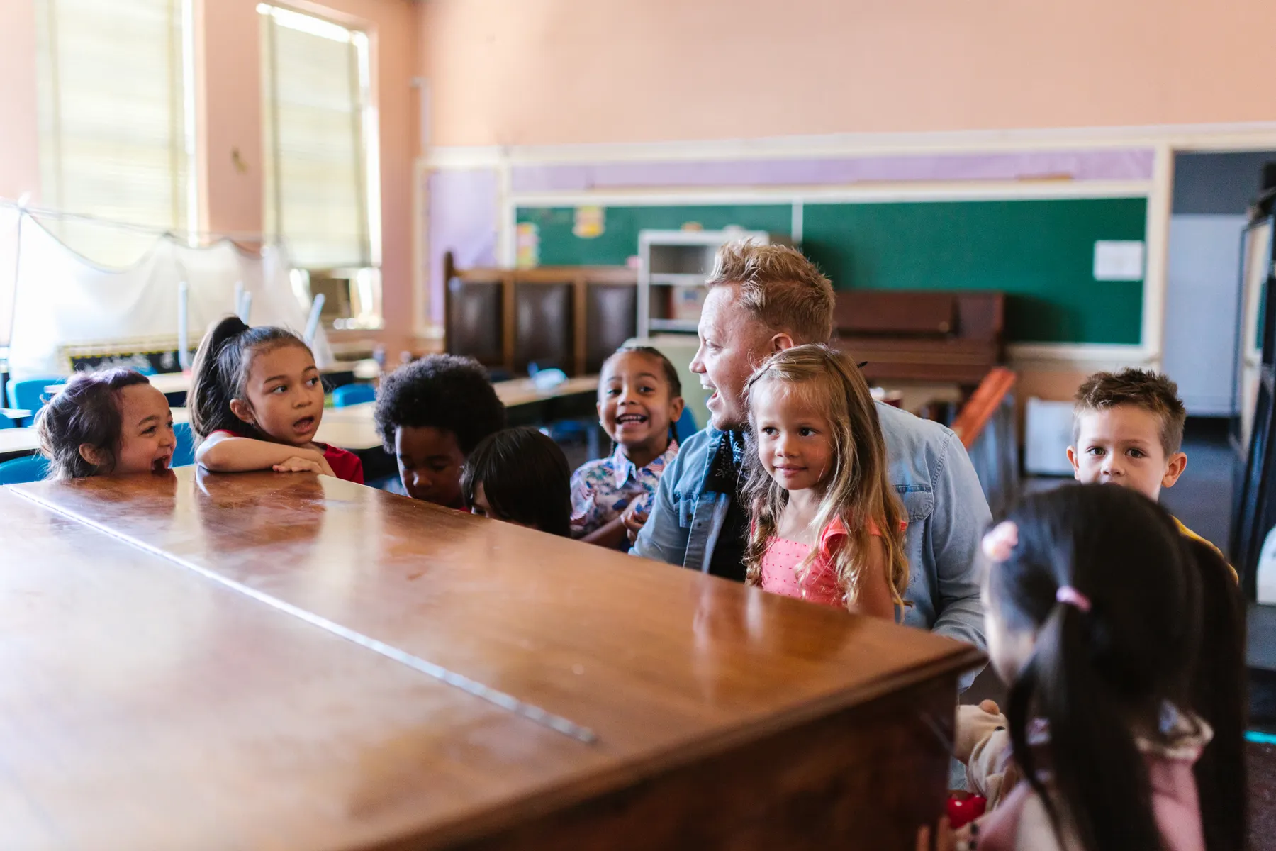 Children exploring learning materials together in a bright classroom