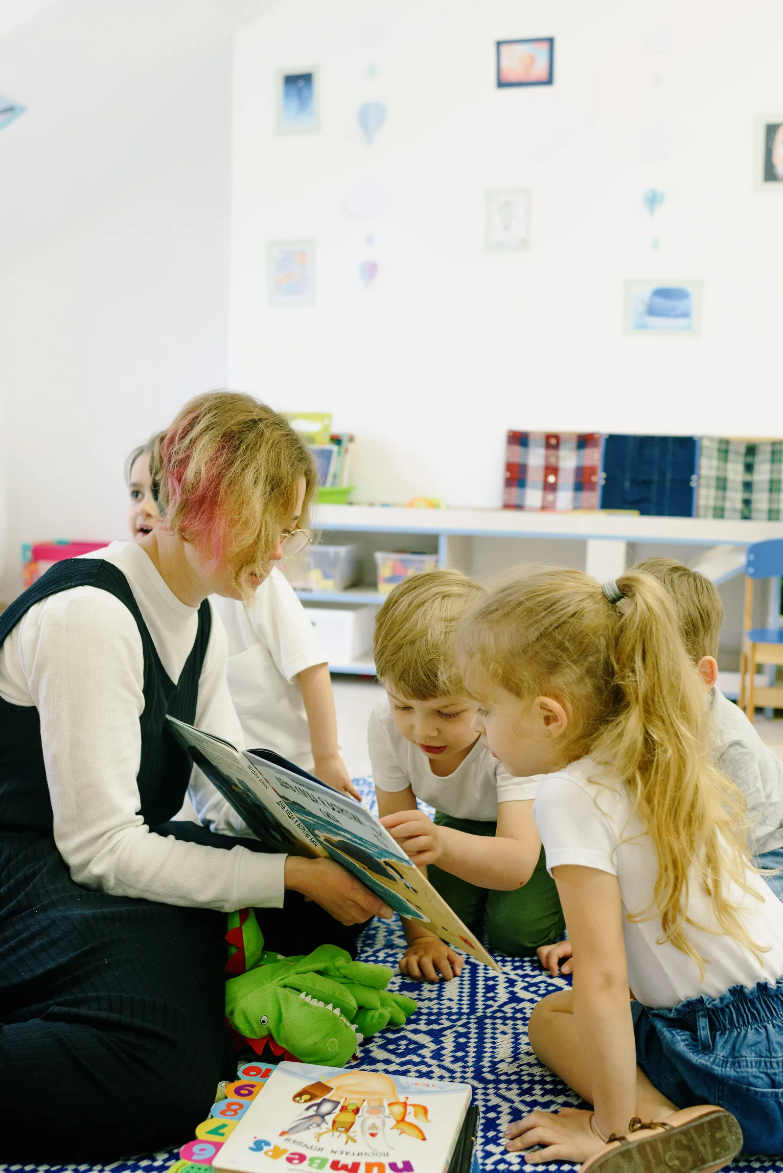 Educator reading with children in a circle